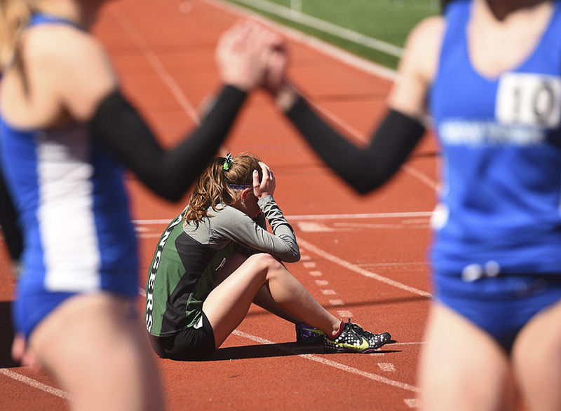 Sports Feature - HM - Wisconsin-Parkside runner Elsie Rehberg sits dejected after the womens 5000m run at the Oliver Nikolof invitiational hosted by the University of Cincinnati. Rehberg finished in 10th place. (Erik Schelkun / Elsestar Images)