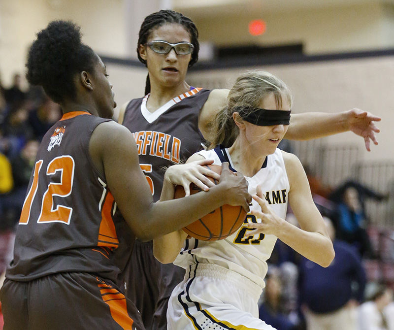 Sports - HM - Notre Dame Academy player Megan Goedde (21) is blindfolded as her sweatband falls over her eyes as she battles for a rebound with Mansfield Senior players Raja Anderson (12) and Jeryn Reese (5) during the first quarter at Toledo Central Catholic High School. (Andy Morrison / The (Toledo) Blade)