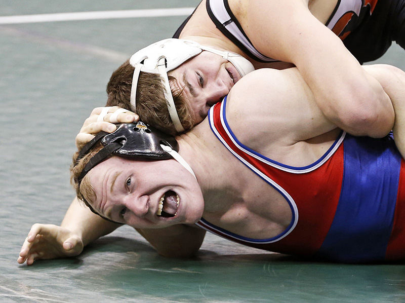 Sports - HM - Lane Hinkle of Mount Vernon (back) wrestles Matt DrGroff of Uniontown Lake at 160 lbs. in Division I during the opening round of the 78th annual OHSAA state wrestling tournament  at the Jerome Schottenstein Center in Columbus.  (Barbara J. Perenic / The Columbus Dispatch)