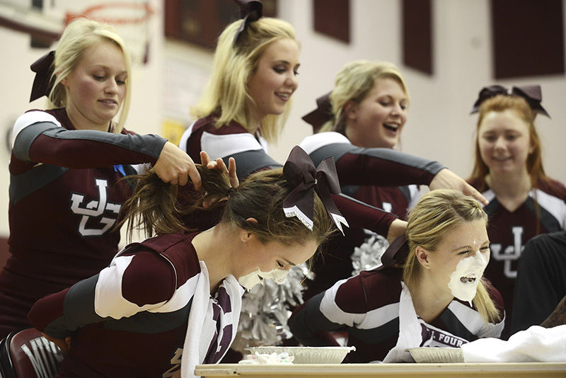 Feature - 2nd place - A contest to see who could find the most gummy worms in a plate full of whipped cream took place during a pep rally for John Glenn High School's boys basketball team. (Chris Crook / Zanesville Times Recorder)