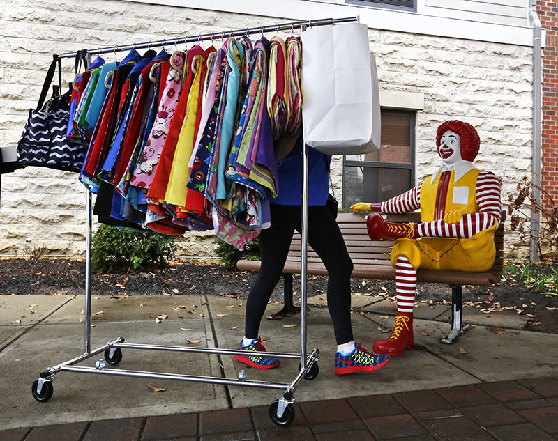 General News - 1st place - Barbara Casados of Capes4Heroes wheels a rack of capes to the Ronald McDonald House of Central Ohio on Livingston Avenue. (Barbara J. Perenic / The Columbus Dispatch)