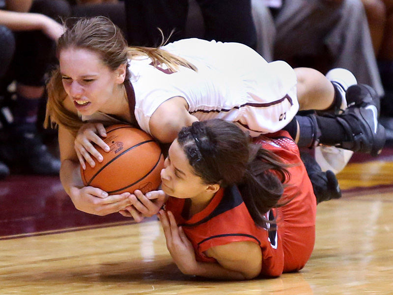 Sports - 1st place - Stow's Lizzie Stefanov (top) and McKinley's Alandria Terrell go after a loose ball in the second quarter of their Div I regional semi final game at the Canton Civic Center. McKinley defeated Stow 45-27. (Scott Heckel / The (Canton) Repository)