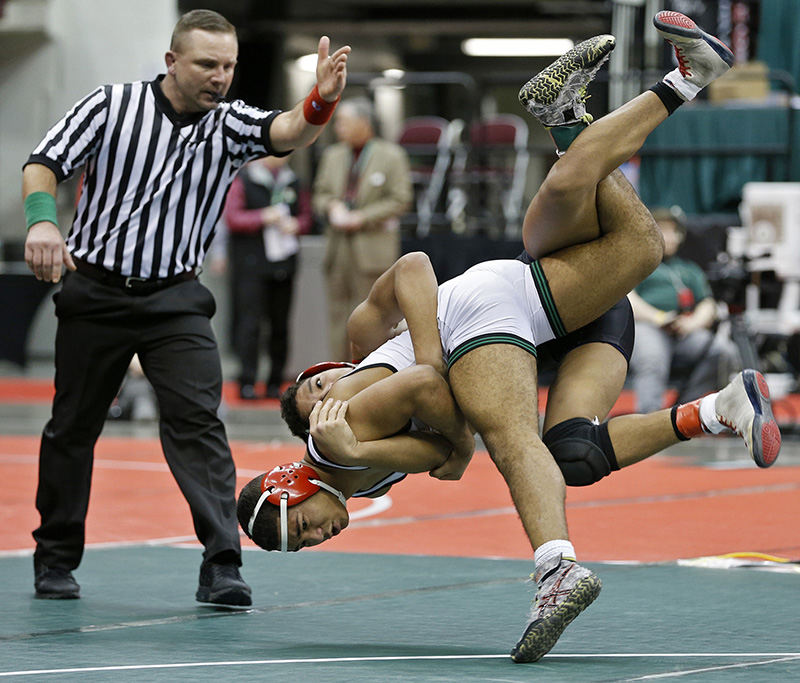 Sports - 2nd place - Dominick Demas of Dublin Coffman wrestles Farouq Muhammed of Shaker Heights in a 145 lb. Div I semi-final match during the state wrestling tournament in Columbus. (Barbara J. Perenic / The Columbus Dispatch)