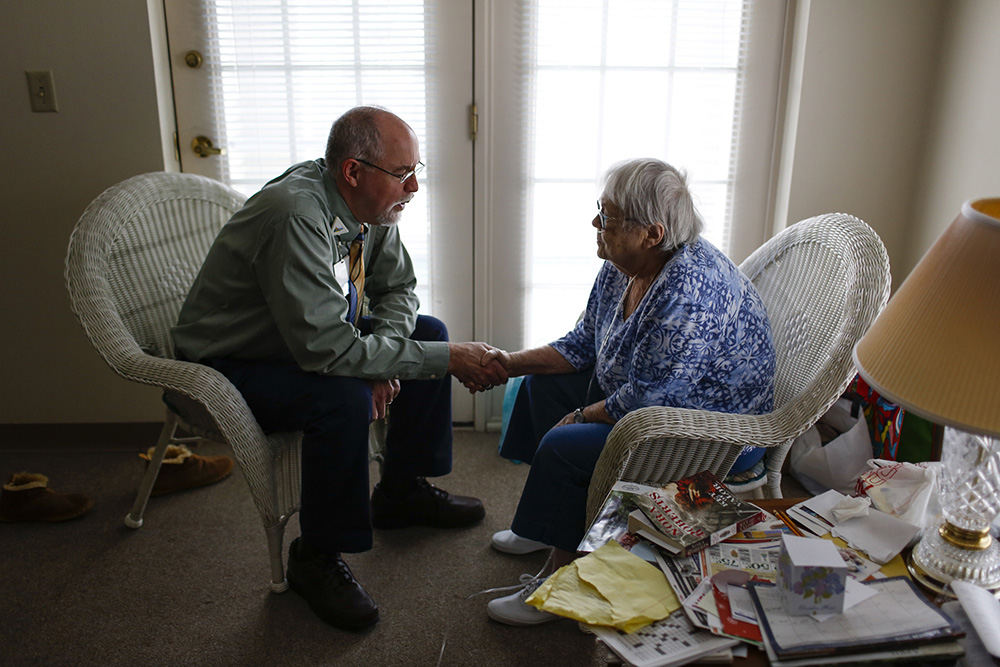 MTFeature - 2nd place - Hospice chaplain John Cramton, left, says a prayer with patient Gretchen Haas, 80, in her assisted care apartment at Whetstone Care Center in Columbus. OhioHealth, who Cramton works with, helps to train local people of faith how to visit and counsel people in hospital care to ease the workload on faith-based ministers. (Joshua A. Bickel / The Columbus Dispatch)