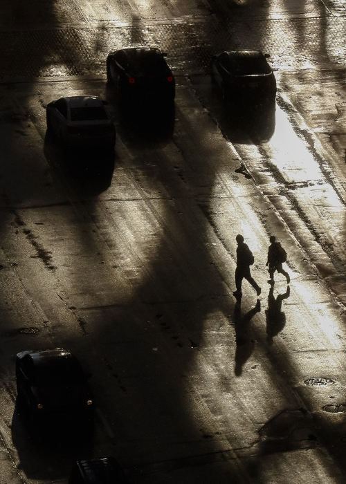 MTFeature - HM - Pedestrians cross Broad Street as sunlight reflects off a nearby building following a snow squall in Columbus.  (Joshua A. Bickel / The Columbus Dispatch)