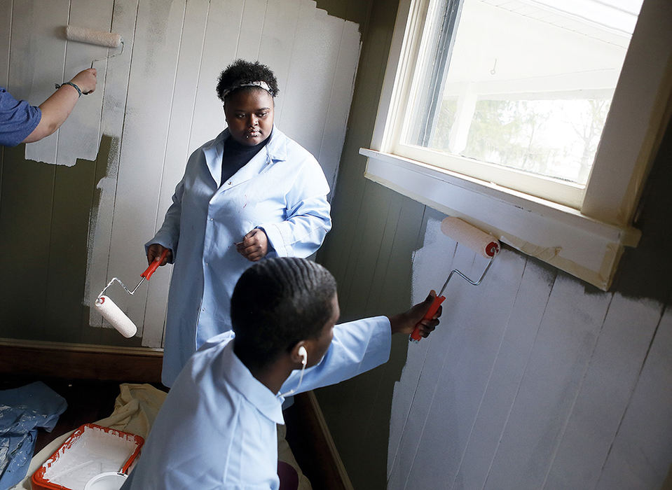 General News - 2nd place - Hiram junior Briana Davis pauses to watch freshman Alex Loney repaint the inside of a room at Hiram Farm during Sugar Day, in Hiram. The event celebrates a "Day of Running Sap," harkening back to 1856 when Hiram students gathered at the town's Udall sugar camp to make maple syrup for community residents. Each year, students spend the day doing community service in honor of the historic day.  (Leah Klafczynski / Akron Beacon Journal)