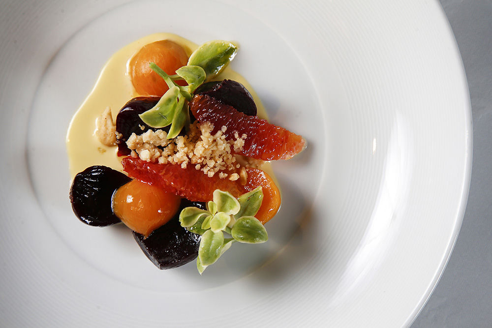 AIllustration - HM - The beet salad, featuring pickled beets, cashew, blood organ and emerald lettuce at Orchids at Palm Court restaurant in Cincinnati.  (Kareem Elgazzar / Cincinnati Enquirer)