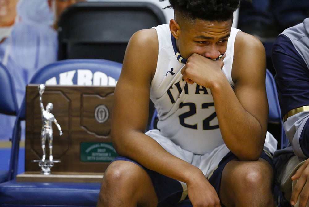 Sports Feature - HM - St. John's Jesuit player Karen Bolden (22) sits dejectedly on the bench with the runner-up trophy after the Titans lost to Massillon Jackson during their Division I regional final basketball game at the University of Akron.   (Andy Morrison / The Blade)