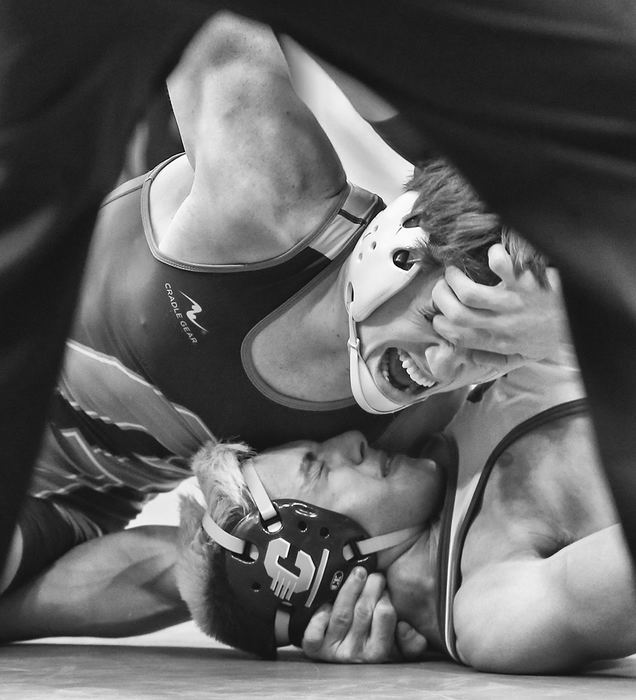    Sports - 2nd place - Kevin Contos of Oregon Clay sticks a finger in the eye of Grove City Central Crossing's Jaden Mattox while being pinned in a 152 pound Division I championship semifinal during the state wrestling tournament at The Jerome Schottenstein Center in Columbus. (Jeremy Wadsworth / The Blade)