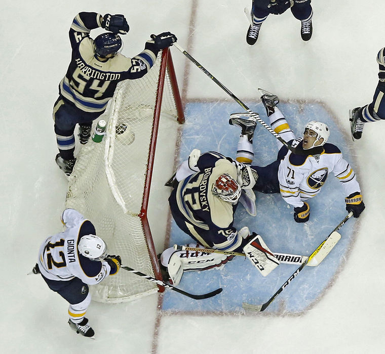 Sports - 3rd place - Columbus Blue Jackets defenseman Scott Harrington (54) gets his stick under the neck of Buffalo Sabres left wing Evan Rodrigues (71) in the 2nd period during their NHL game at Nationwide Arena in Columbus.   (Kyle Robertson / The Columbus Dispatch)