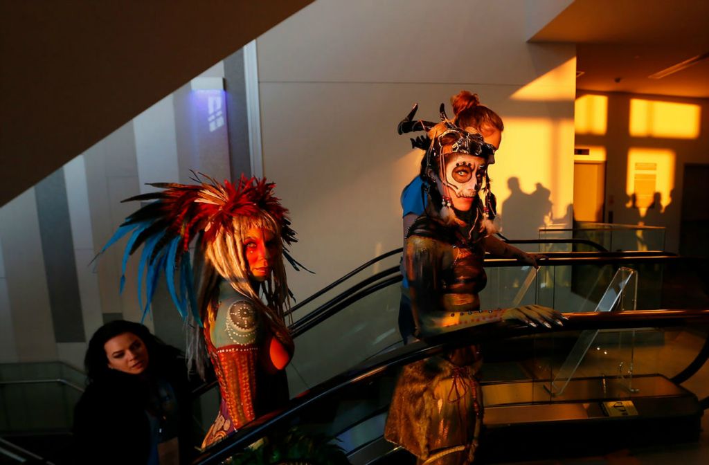 Feature - 1st place - Body painting competitors Hannah Newmyer of Williard, (right) and Sharon Kelly of Troy, ride the escalator into the finals of the Arnold Classic bodybuilding competition at the Battelle Grand Ballroom in the Greater Columbus Convention Center on March 7, 2020. Newmyer was painted by Nancy Mayer of New London, and Kelly was painted by Karyn Fox of Cincinnati.   (Adam Cairns / The Columbus Dispatch)