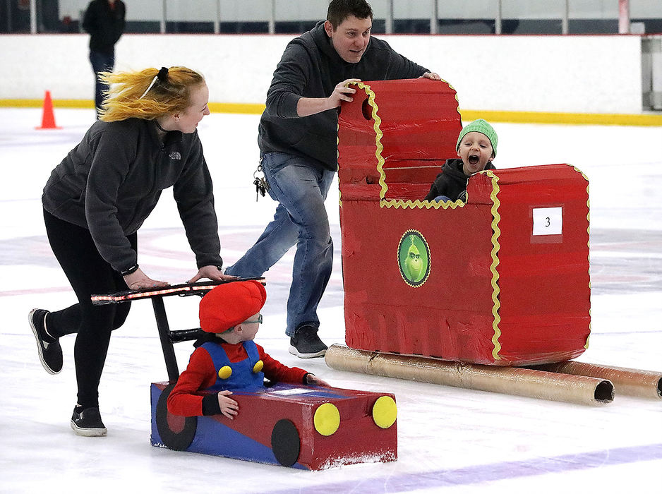 Feature - 3rd place - Charlie and Bridget Capper (left) race Levi and Dallas Hill during the annual Cardboard Classic Bobsled Races held at The Chiller ice skating rink. The 6th annual event was sponsored by the National Trail Parks and Recreation District. Teams of families and friends pushed the sleds, all made of cardboard, tape, glue with a pilot on board, down the ice. The teams raced against each other and the clock for prizes.  (Bill Lackey / Springfield News-Sun)