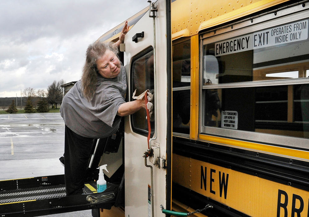 General News - 3rd place - New Bremen school bus driver Jackie Crites works to sanatize the busses as deep cleaning continues at New Bremen High School. Schools were shut down for 3-weeks because of the Coronavirus by Ohio Governor Mike Dewine. (Daniel Melograna / The Daily Standard)