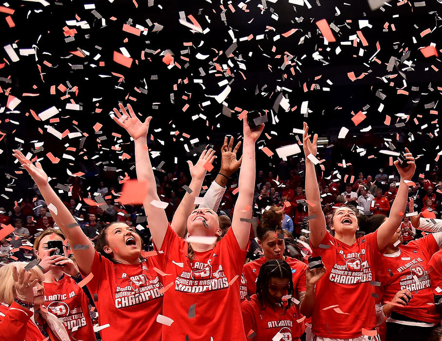 Sports Feature - 1st place - Members of the Dayton Flyers women's basketball team reach for confetti after winning the A10 conference tournament by defeating VCU 52-48. (Erik Schelkun / Elsestar Images)