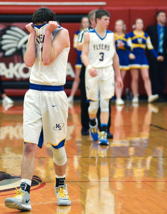 Sports Feature - 3rd place - Marion Local's Bryce Moeller (11) covers his face in disappointment after fouling New Bremen's Nola Bornhorst in the closing seconds of overtime in the Division IV district semifinals at Wapakoneta High School. (Daniel Melograna / The Daily Standard)