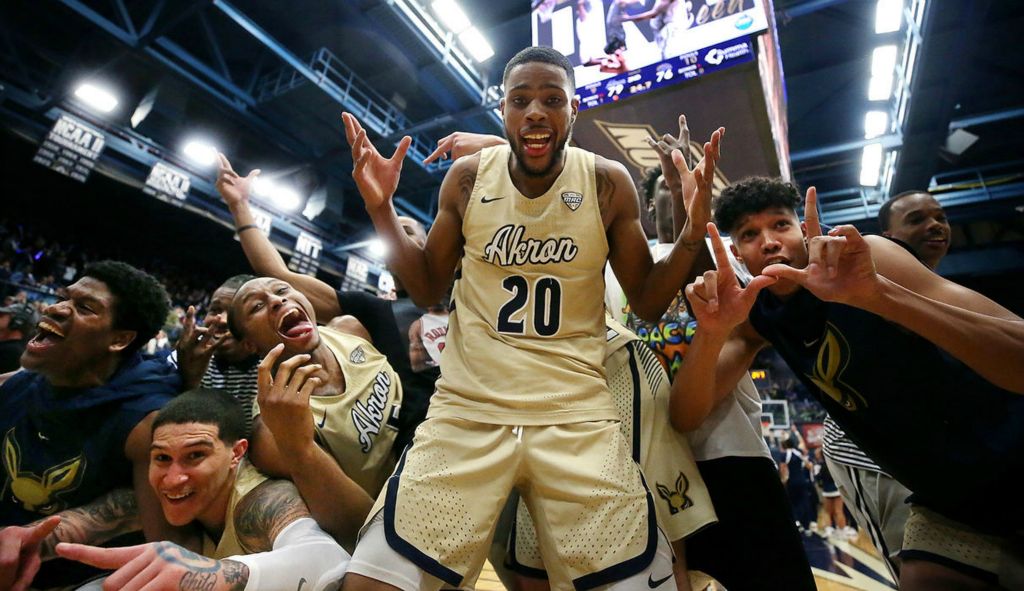 Sports Feature - HM - Akron forward Xeyrius Williams (center) is mobbed by teammates after the Zips clinched the number one seed after defeating Kent State, 79-76, at James A. Rhodes Arena in Akron. (Jeff Lange / Akron Beacon Journal)