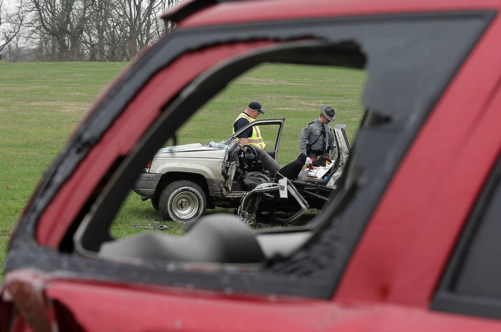 Spot News - 2nd place - A Springfield Township firefighter and a member of the Ohio Highway Patrol look over a stolen Jeep Grand Cherokee after the driver had to be cut out of the vehicle on South Bird Road. The driver was fleeing law enforcement when she struck the SUV in the foreground and lost control. She was taken by Mobile Intensive Care Unit to Miami Valley Hospital with serious injuries. The male passenger was not injured and was taken into custody. The driver of the SUV that they struck was not injured.  (Bill Lackey / Springfield News-Sun)