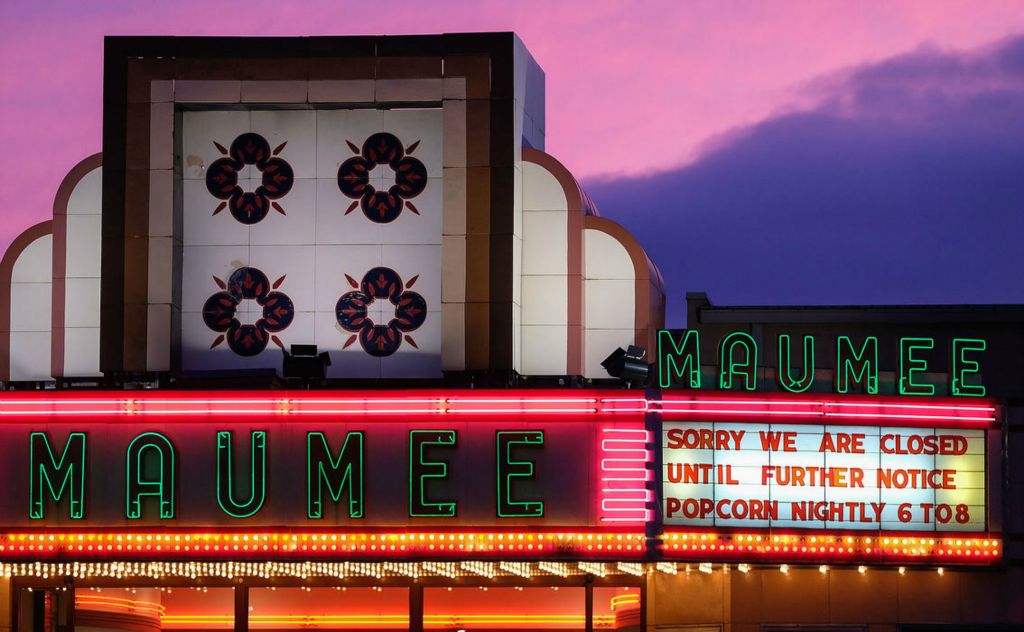 Story - 1st place - The sunset shows behind the Maumee Indoor Theatre in Maumee, on Friday, March 20, 2020. Although the theatre is not showing movies until further notice due to COVID-19, they are serving patrons "take out" popcorn 6 p.m. to 8 p.m. nightly.  (Kurt Steiss / The Blade)