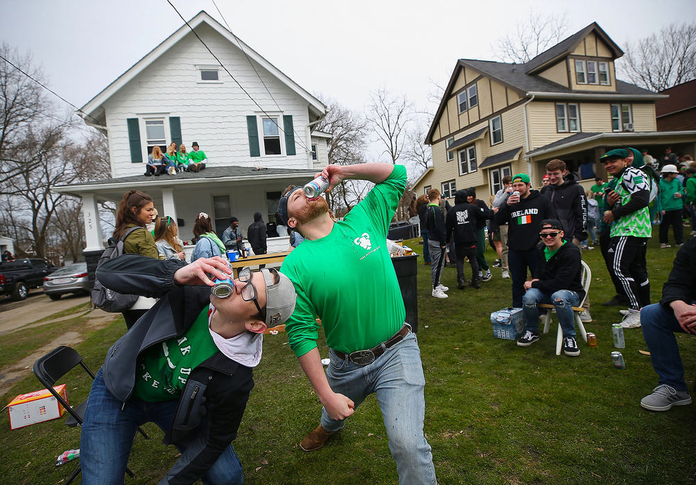 Story - 2nd place - Kent State students party on the front lawn of their home on Summit Street during the Fake Paddy's Day celebration, Saturday, March 14, 2020, in Kent. (Jeff Lange / Akron Beacon Journal)