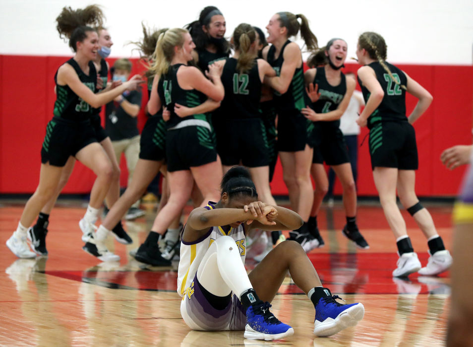 Sports Feature - 2nd place - Reynoldsburg's Imarianah Russell sits alone on the court as Dublin Coffman players celebrate a 60-57 win behind her in a Division I regional semifinal game at Westerville South High School. Russell spent her first two varsity seasons at Dublin Coffman before joining the Raiders for the 2020-21 season. (Shane Flanigan / ThisWeek Community News)