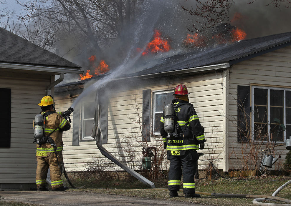 Spot News - 3rd place - Springfield Township fire crews, along with Mad River Township and City of Springfield, battle a fully involved house fire at 2159 Duquesne Drive. The homeowners, who were home at the time, escaped injury. The home, however, suffered extensive damage with flames burning through most of the roof.  (Bill Lackey / Springfield News-Sun)