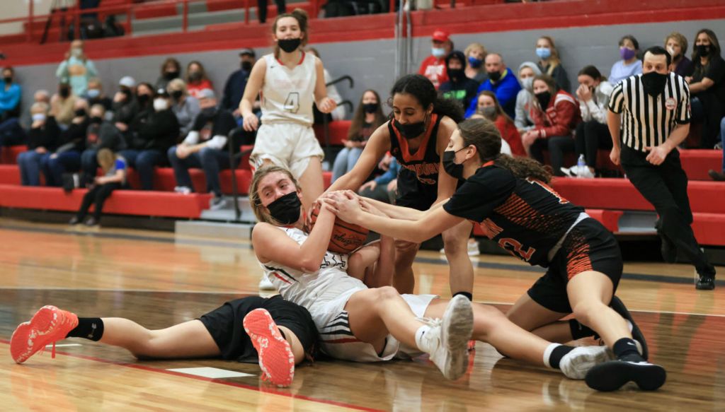 Sports - 2nd place - Bedford’s Sophia Gray battles Dearborn High School’s Natalia Salame (on floor), Malak Alhajj, and Katya Salame for the ball during a Division I MHSAA regional basketball final in Temperance, Michigan. Bedford defeated Dearborn, 46-43.  (Jeremy Wadsworth / The Blade)