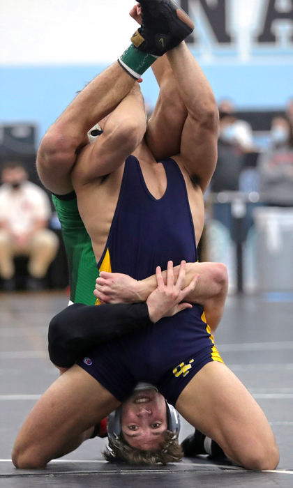 Sports - 3rd place - Highland's William Scavuzzo, bottom, flips over Wayne's Braxton Lawson during their 160 pound match in the Division I state wrestling tournament at Hilliard Darby High School. (Jeff Lange / Akron Beacon Journal)