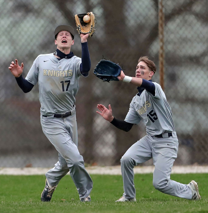 Sports - HM - Hoban left fielder Thomas Crowe (left) catches a fly ball hit by Cuyahoga Falls' Brady Semick as Parker Falkenstein backs him up during the third inning of a game in Akron. (Jeff Lange / Akron Beacon Journal)