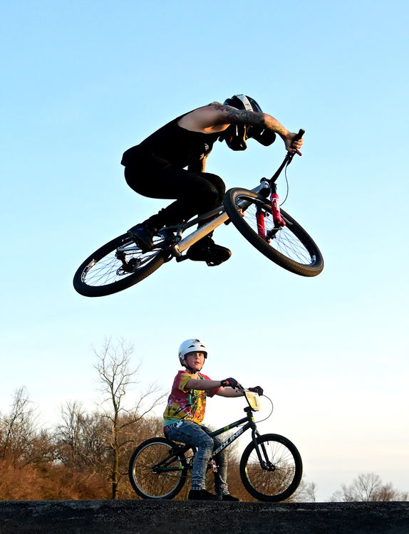 Feature - 3rd place - Professional Cyclist Tommy Zula jumps over a fan during a recent practice session at the new pump track in Huber Heights. (Erik Schelkun / Elsestar Images)