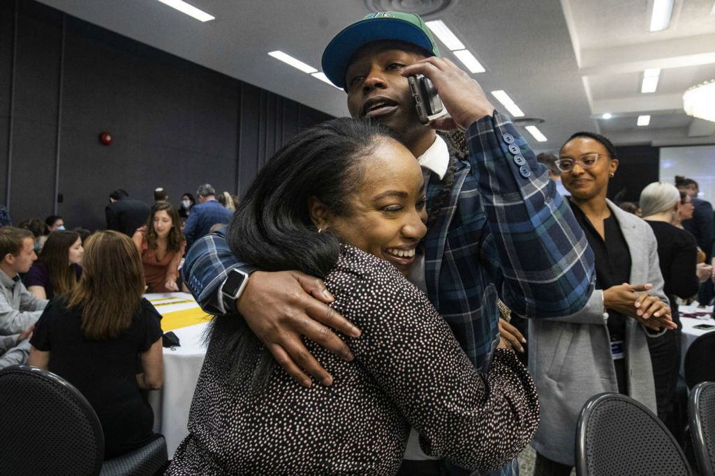 General News - 3rd place - Jemila Counci and Antonio Jackson hug after learning their residency placements during The University of Toledo’s annual Match Day celebration at the Stranahan Theater in Toledo. (Rebecca Benson / The Blade)