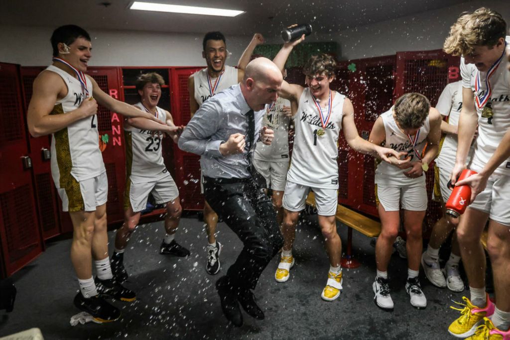 Sports Feature - 1st place - Northview’s Jeremy McDonald (center) dances as the team sprays him with water after winning the Division I district basketball finals against Whitmer at Central Catholic High School in Toledo. (Isaac Ritchey / The Blade)