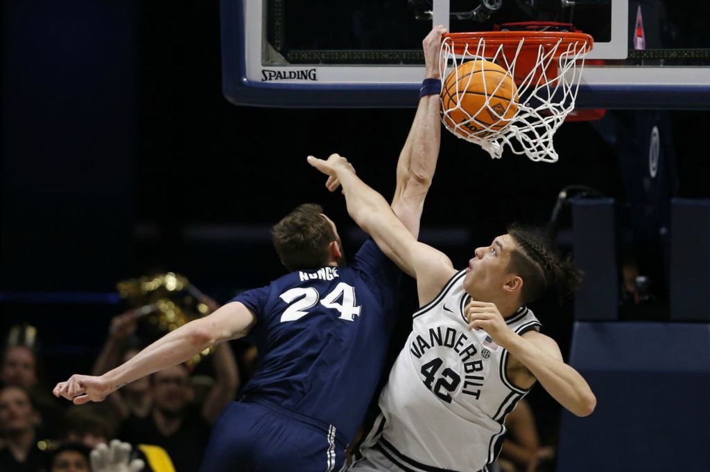 Sports - 1st place - Xavier forward Jack Nunge (24) dunks over Vanderbilt’s Quentin Millora-Brown (42) in the first half of the NIT quarter final game at the Cintas Center in Cincinnati. (Sam Greene / The Cincinnati Enquirer)