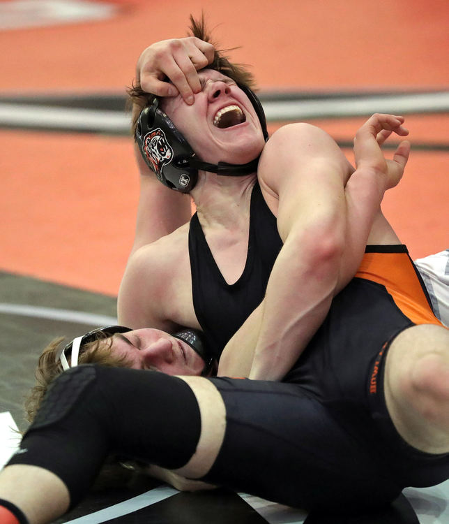 Sports - 2nd place - Aurora’s Bo DiJulius (bottom) gouges the eye of Howland’s Carter Mock to be disqualified from the Division II district tournament during their 144 pound quarterfinal match at Perry High School. (Jeff Lange / Akron Beacon Journal)