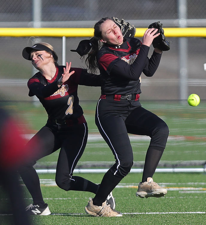 Sports - 3rd place - Stow centerfielder Marissa Romano (left) collides with left fielder Casey Marousch as they both attempt to make a play for a fly ball hit by Hoban’s Ellie Hardman during the fourth inning of a softball game in Akron. (Jeff Lange / Akron Beacon Journal)