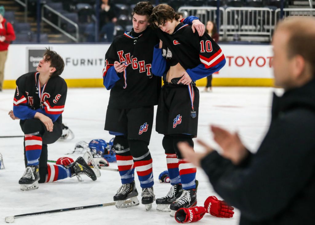 Story - 2nd place - St. Francis De Sales’s Noah Egan (left) consoles Chris Meyer after falling to Gates Mills Gilmour, 2-1, in triple overtime the state hockey championship game at Nationwide Arena in Columbus. (Isaac Ritchey / The Blade)