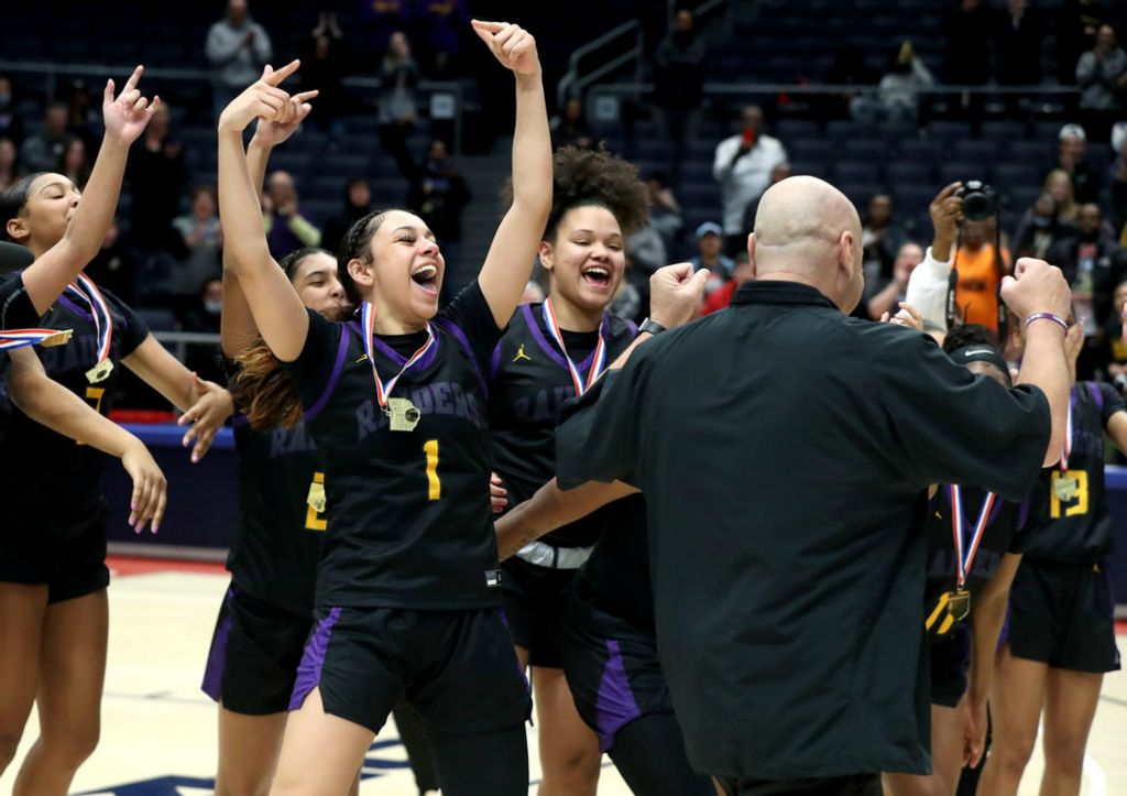 Story - 3rd place - Reynoldsburg's Mya Perry (1) cheers on head coach Jack Purtell with teammates as he receives his championship medal after the Raiders defeated Mason in overtime, 63-56, in the OHSAA Division I state championship game at UD Arena in Dayton, Ohio. (Shane Flanigan / ThisWeek Community News)