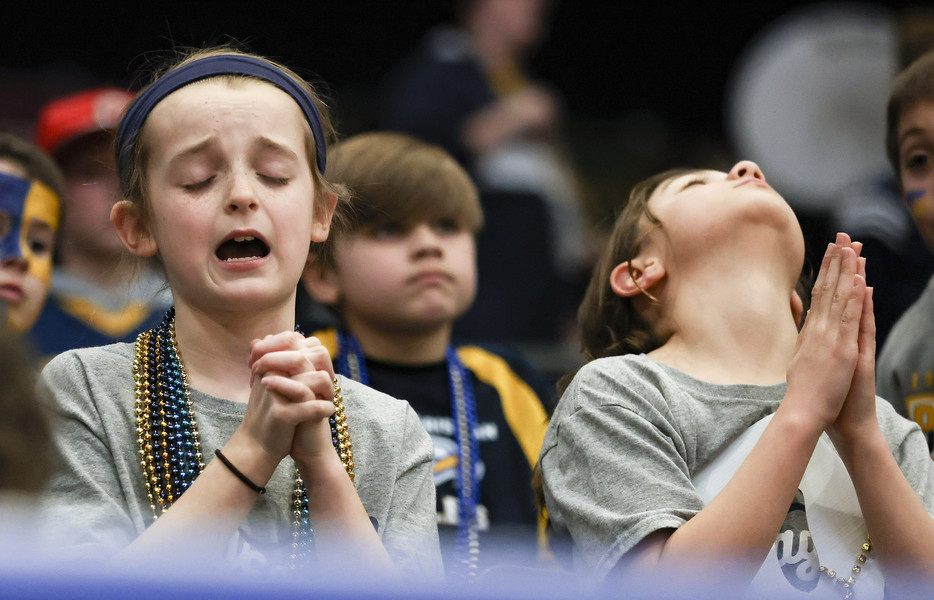 Sports Feature - 1st place - Girls with Toledo Christian pray during the final seconds of the Division IV girls high school basketball final at the University of Dayton Arena. Toledo Christian fell to New Madison, 52-50.  (Rebecca Benson / The Blade)