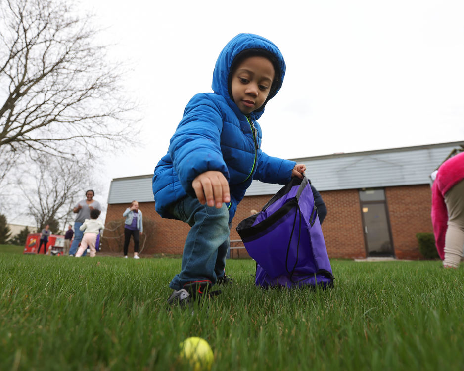 Feature - 3rd place - Three-year-old Brixton Livous grabs eggs during the inaugural Purple Day Egg Hunt at the Epilepsy Center of Northwest Ohio in Toledo.  (Jonathan Aguilar / The Blade)