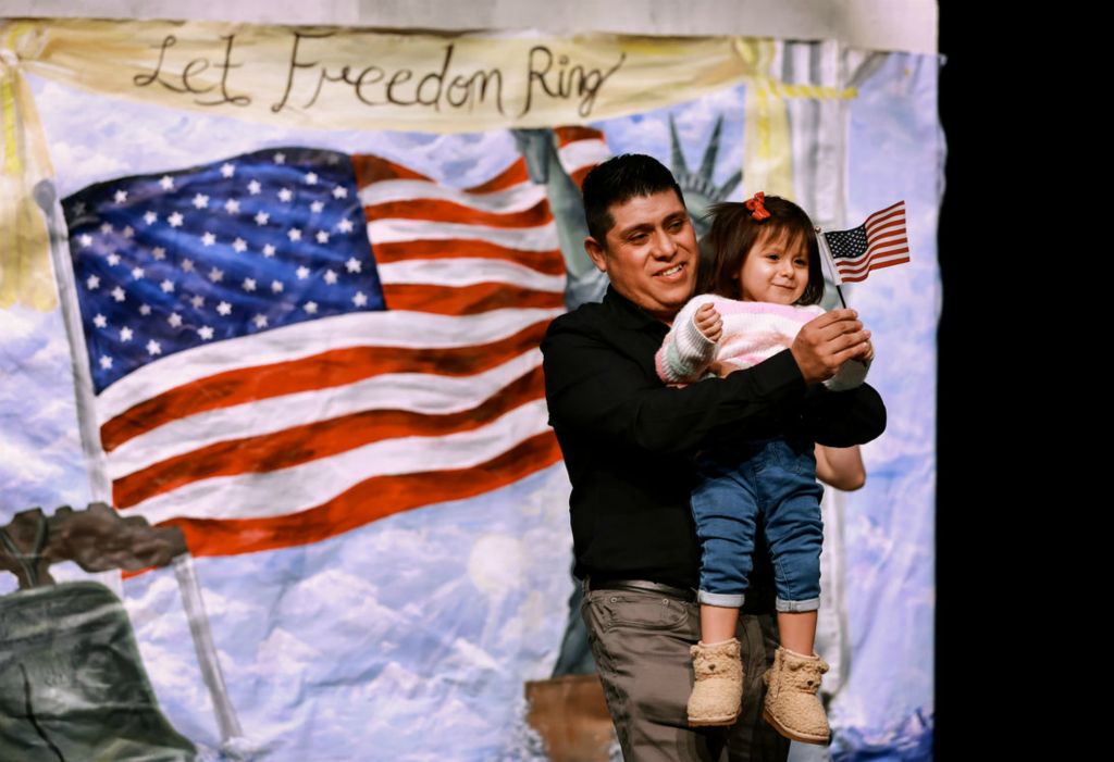 General News - 1st place - Arturo Garcia, originally from Mexico, celebrates becoming a U.S. citizen with his daughter Arysa, 2, during a Naturalization Ceremony at Sylvania Southview High School in Sylvania.  (Jeremy Wadsworth / The Blade)