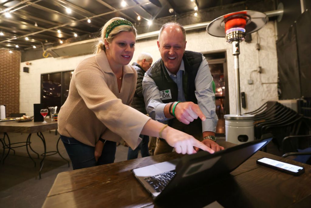 General News - HM - Julie MacMillan and Adam Fineske, Superintendent of Ottawa Hills Local Schools, smile as the results of the Ohio primary look promising for passing the district's levy during an election watch party at Poco Piatti in Toledo.  (Jonathan Aguilar / The Blade)