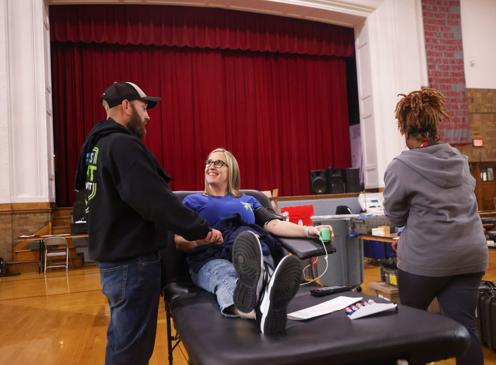 General News - HM - Ed Stanley (left) comforts Corri Stanley before she gives blood during a blood and toy drive in honor of their 4-year-old son Colton Stanley, who is fighting T-cell Lymphoblastic Lymphoma, at Central Catholic High School in Toledo. (Kurt Steiss / The Blade)