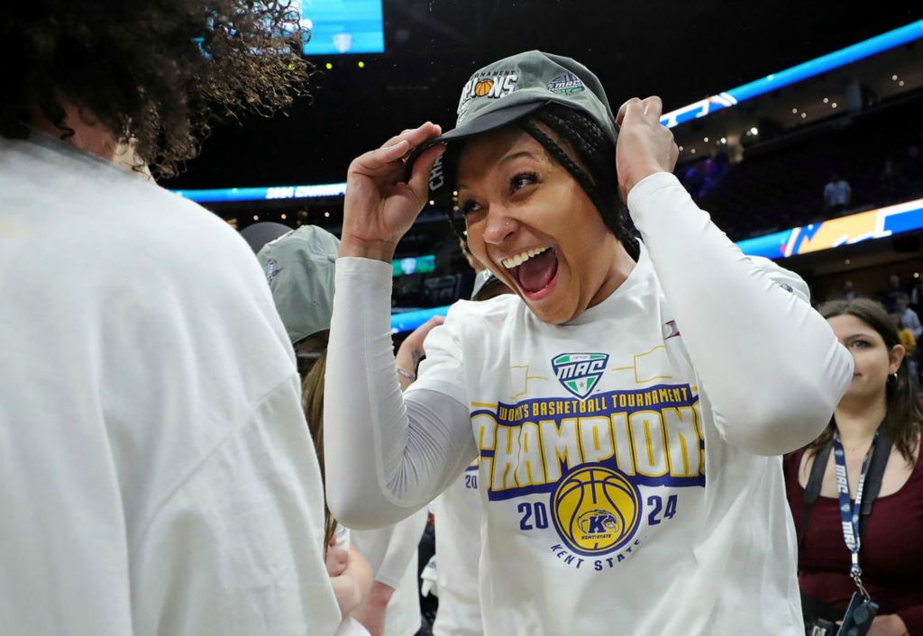 Sports Feature - 2nd place - Kent State Golden Flashes forward Janae Tyler (34) is all smiles as she puts on her cap after winning the Mid-American Conference Tournament women’s championship game at Rocket Mortgage FieldHouse in Cleveland. (Jeff Lange / Akron Beacon Journal)