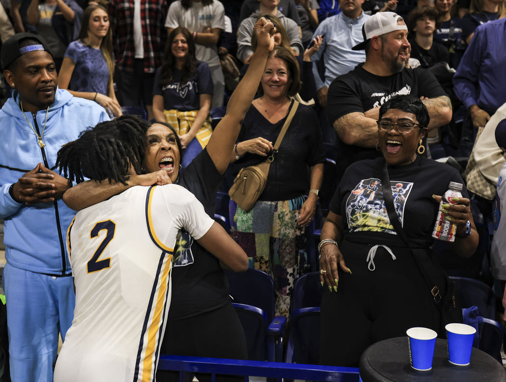 Sports Feature - 3rd place - Whitmer’s Antione West celebrates his win over St. John’s with a loved one in the Division I regional semifinal game at the University of Toledo’s Savage Arena. (Rebecca Benson / The Blade)