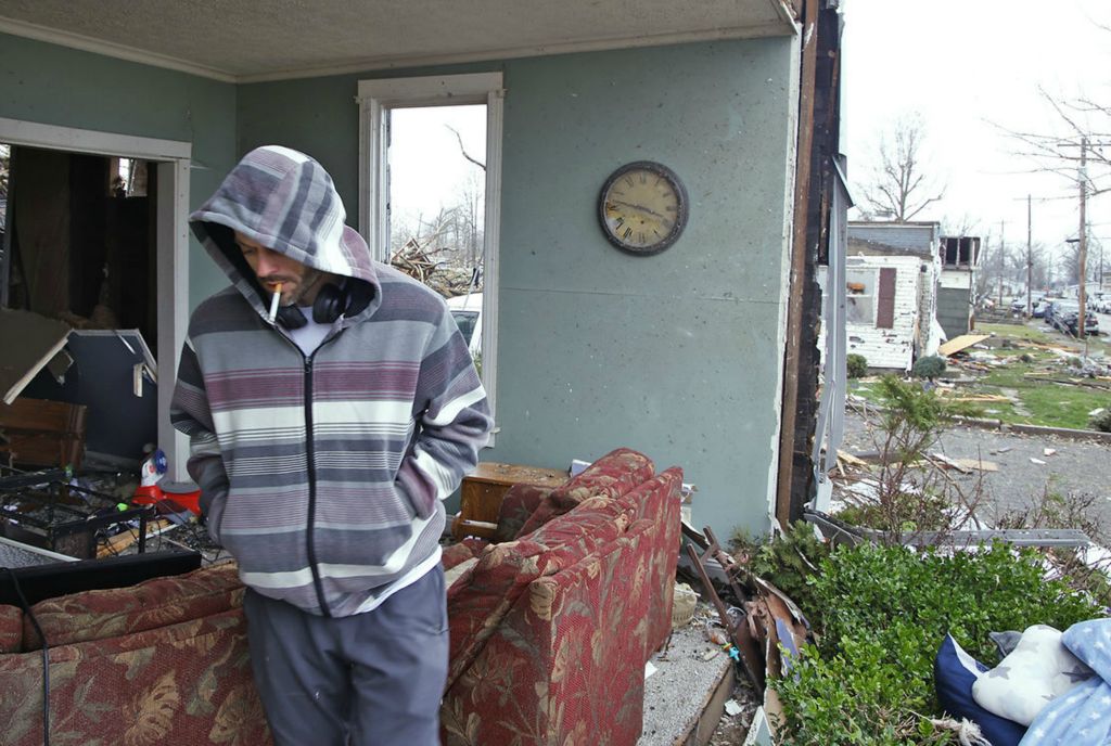 Spot News - 3rd place - Blaine Schmitt looks for his mother's cremation ashes in what's left of his living room in Lakeview. The front wall of Schmitt's two story house was gone after a tornado destroyed most of Lakeview.  (Bill Lackey / Springfield News-Sun)