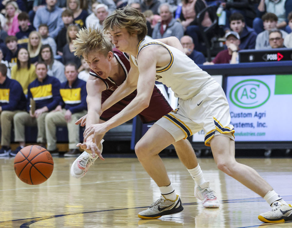 Sports - 1st place - Archbold’s Sonny Phillips and Paulding’s Blake Rhonehouse lunge after a loose ball during a district semifinal game at Napoleon High School. (Rebecca Benson / The Blade)