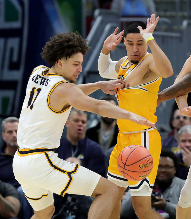 Sports - HM - Toledo Rockets guard Sam Lewis (11) yanks on the jersey of Kent State guard Giovanni Santiago (11) as he controls the ball during the first half of a game in the quarterfinals of the Mid-American Conference Tournament at Rocket Mortgage FieldHouse in Cleveland. (Jeff Lange / Akron Beacon Journal)