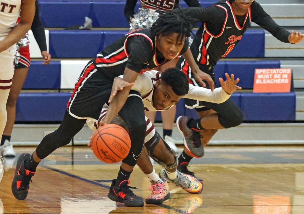 Sports - HM - Rogers’ Jayden Baker (left) steals the ball from Scott’s Ahmad Boone during a Division II district semifinal game at Lake High School in Millbury. (Kurt Steiss / The Blade)