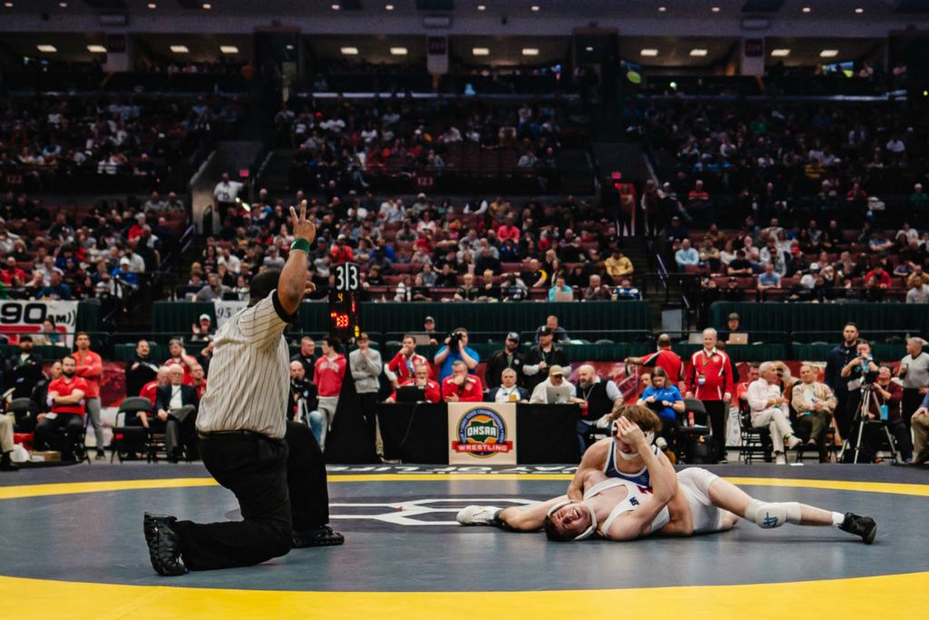 Story - 1st place - Indian Valley's Leroy Steagall (bottom) wrestles St. Mary's Memorial's Tate Hisey during championship finals on day three of the Ohio High School Athletic Association 2024 state wrestling championships, at The Ohio State University’s Jerome Schottenstein Center, in Columbus. (Andrew Dolph / The Times Reporter)