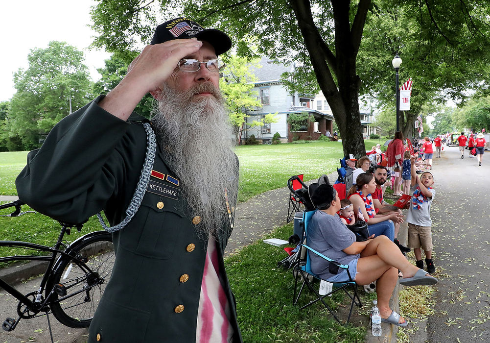 General News - 2nd placeVietnam veteran Jarvis Kettlehake salutes as a Memorial Day Parade float representing a fallen veteran passes by along Fountain Avenue. (Bill Lackey/Springfield News-Sun)