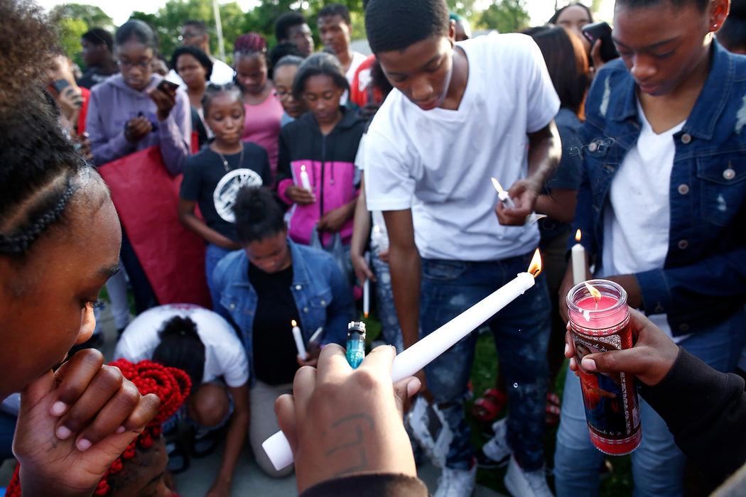 General News - HMYoung people light candles in memory of Jaykwon "Bobby" Sharp, 14, who was shot and killed near this spot on Shady Lane, where Shady Lane Elementary School and Sherwood Middle School are located. Sharp was an 8th grader at the middle school. (Fred Squillante/The Columbus Dispatch)